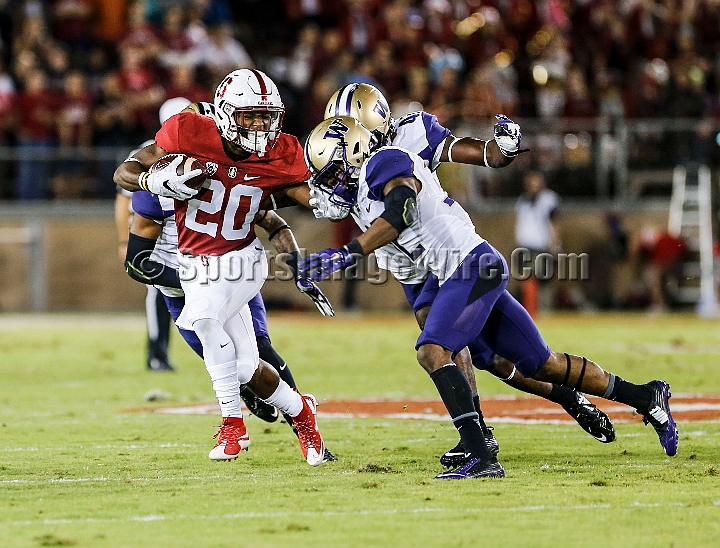 2015StanWash-044.JPG - Oct 24, 2015; Stanford, CA, USA; Stanford Cardinal running back Bryce Love (20) catches a pass for 12 yards and a first down in the first quarter before being tackled by Washington Huskies defensive back Budda Baker (32) and linebacker Cory Littleton (42) at Stanford Stadium. Stanford beat Washington 31-14.
